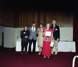 President Bruce Grube and Lee Bird stand with the parents of Dennis Thayer and the winner of the Thayer award at the Excellence in Leadership awards dinner, St. Cloud State University