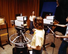 Man and woman operate television cameras, St. Cloud State University