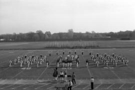 Marching band performing on a football field, St. Cloud State University