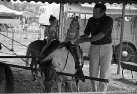 A girl rides a pony at the Benton County Fair