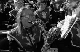 A woman plays an instrument at the homecoming football game, St. Cloud State University