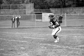 St. Cloud State football player Keith Nord runs with the football in a game against St. John's University