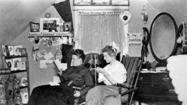 Two female students relax in their Lawrence Hall (1905) dormitory room, St. Cloud State University