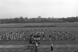 Marching band performing on a football field, St. Cloud State University