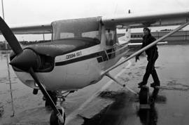 Darek Kurplus of the Aero Club inspects a plane at the National Intercollegiate Flying Association Region 5 Air Meet, St. Cloud State University