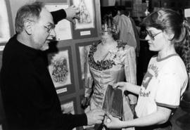 Harvey Jurik shows a student a costume, St. Cloud State University