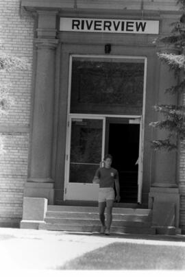 Man walks out Riverview (1913) front door, St. Cloud State University