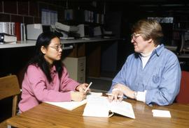 Librarian Chris Inkster helps a student, St. Cloud State University