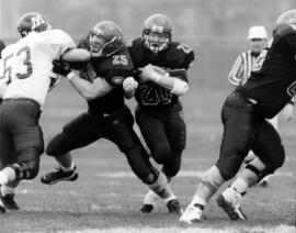 Randy Martin runs with a football during a game, St. Cloud State University