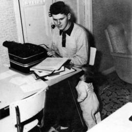 A man uses a typewriter at the Veteran's Housing (1946) complex, St. Cloud State University