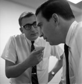 Mike Kobluk of the Mitchell Trio is interviewed by WJON's Mike Diem before their concert at Halenbeck Hall (1966), St. Cloud State University