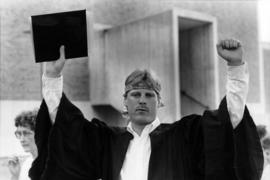 Man celebrates graduation after commencement, St. Cloud State University