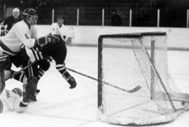 Hockey player Mike Turgeon scores a goal against St. John's University, St. Cloud State University