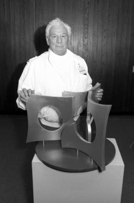 Artist Charles Huntington with a model of his sculpture "Perspectives," St. Cloud State University