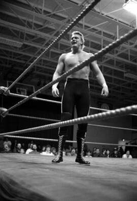 Wrestler Wayne Bloom stands in the ring during a match at the Sauk Rapids High School