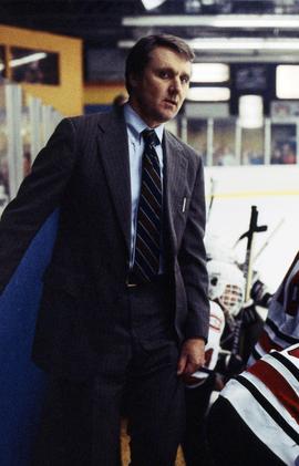 Herb Brooks coaches a hockey game behind the bench, St. Cloud State University