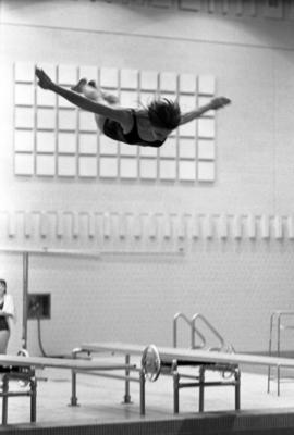 Woman diver competes in a meet against the University of Minnesota, St. Cloud State University