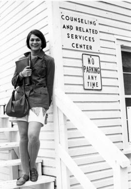 A student stands outside of the Counseling Center in "B" Building (1947), St. Cloud State University