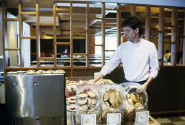 Man readies food at Garvey Commons (1963), St. Cloud State University