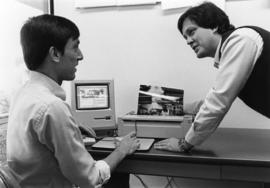 Keith Ewing shows a student a printer, St. Cloud State University