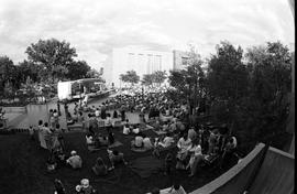 People gather near a stage to watch a performer, Lemonade Concert and Art Fair, St. Cloud State University