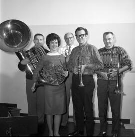 Men and women stand together with musical instruments, St. Cloud State University