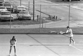 Two women play tennis, St. Cloud State University