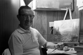 Harry Goehring with his painting, St. Cloud State University