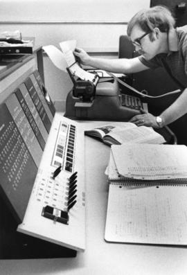 Man works at a typewriter, St. Cloud State University