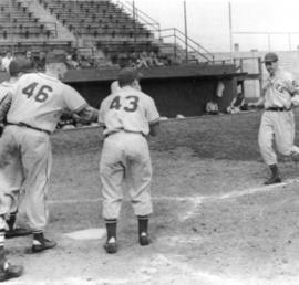 "Tom Bell, Dick Fredeen, and Joe Glatzmaier extend hands to Jack Kelly as he completes a home run against St. John's at the Rox ball park", St. Cloud State University