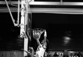 St. Cloud State University basketball player Dan Hagen dunks a basketball during a game against the University of Minnesota-Duluth