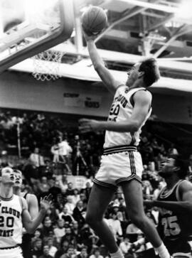 Basketball player Terry Kuechle drives toward the basketball hoop during a game, St. Cloud State University