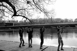 Rowing Club members lift their boat, St. Cloud State University
