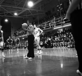 Basketball player Jack Harrison readies to take a free throw against Mankato State University in men's basketball at Eastman Hall (1930), St. Cloud State University