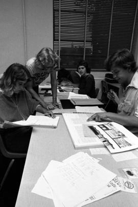 Students Karen Zumbusch, Sue Christian, Jim Maloney, and Kyle Welke work on editing news stories at a Mass Communications workshop, St. Cloud State University