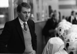 Herb Brooks coaches a hockey game behind the bench, St. Cloud State University