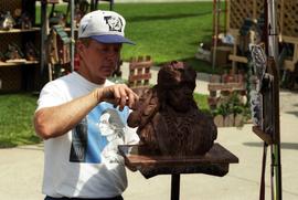 A man carves a bust, Lemonade Concert and Art Fair, St. Cloud State University