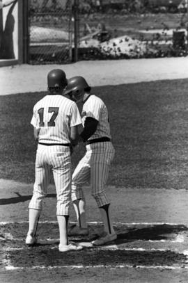 Bob Hegman welcomes Jim Eisenreich at home plate during a St. Cloud State University baseball game against the University of Minnesota-Duluth