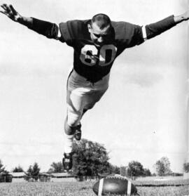 Mike Rybak leaps on a football, St. Cloud State University