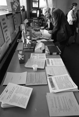 Winter Institute attendees look at material at a booth, St. Cloud State University