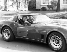 Homecoming parade grand marshal Vernie McDonald rides in a car, St. Cloud State University