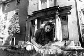 Woman studies in front of Lawrence Hall (1905), St. Cloud State University