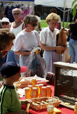 People look at a merchandise at a booth, Lemonade Concert and Art Fair, St. Cloud State University