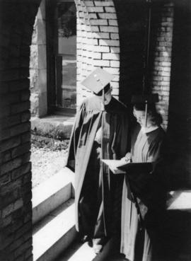 Two graduating students stand together, St. Cloud State University