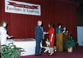 Brendan McDonald congratulates a student receiving the Excellence in Leadership award, St. Cloud State University