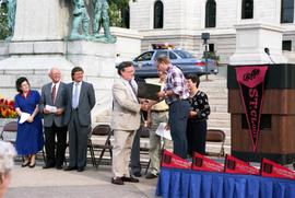 Minnesota Governor Arne Carlson shakes the hand of Robert Bess at the 125th anniversary celebration for St. Cloud State