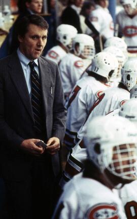 Herb Brooks coaches a hockey game behind the bench, St. Cloud State University