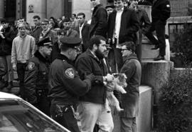 Doug Erickson is led away by police during a protest against the Vietnam War at the Stearns County Courthouse