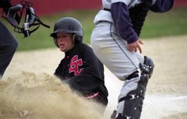 Karissa Hoehn slides into home plate during a softball game, St. Cloud State University