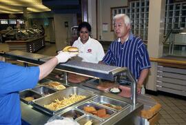 President Roy Saigo is served food at Garvey Commons (1963), St. Cloud State University